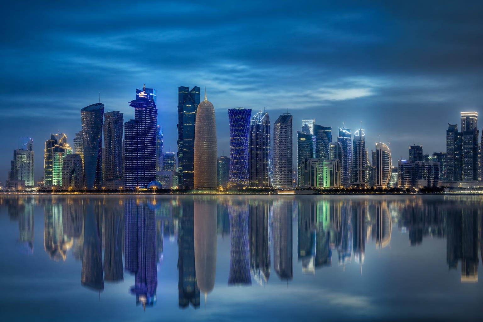 Doha, Qatar skyline at blue hour reflected in the water